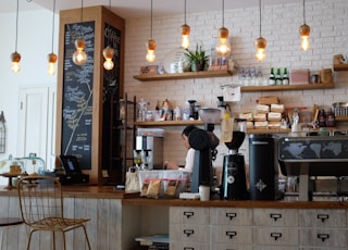 black kitchen appliance on kitchen island with pendant lights