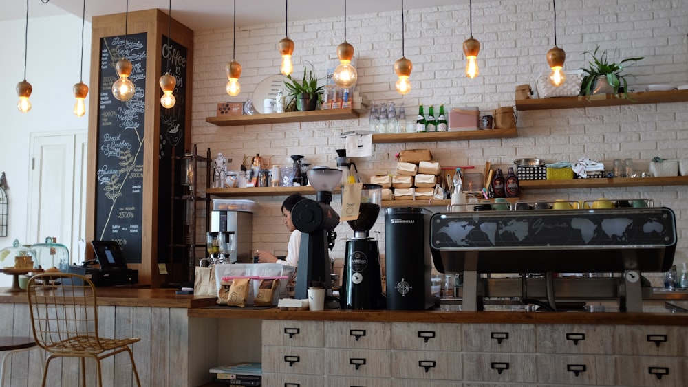 black kitchen appliance on kitchen island with pendant lights