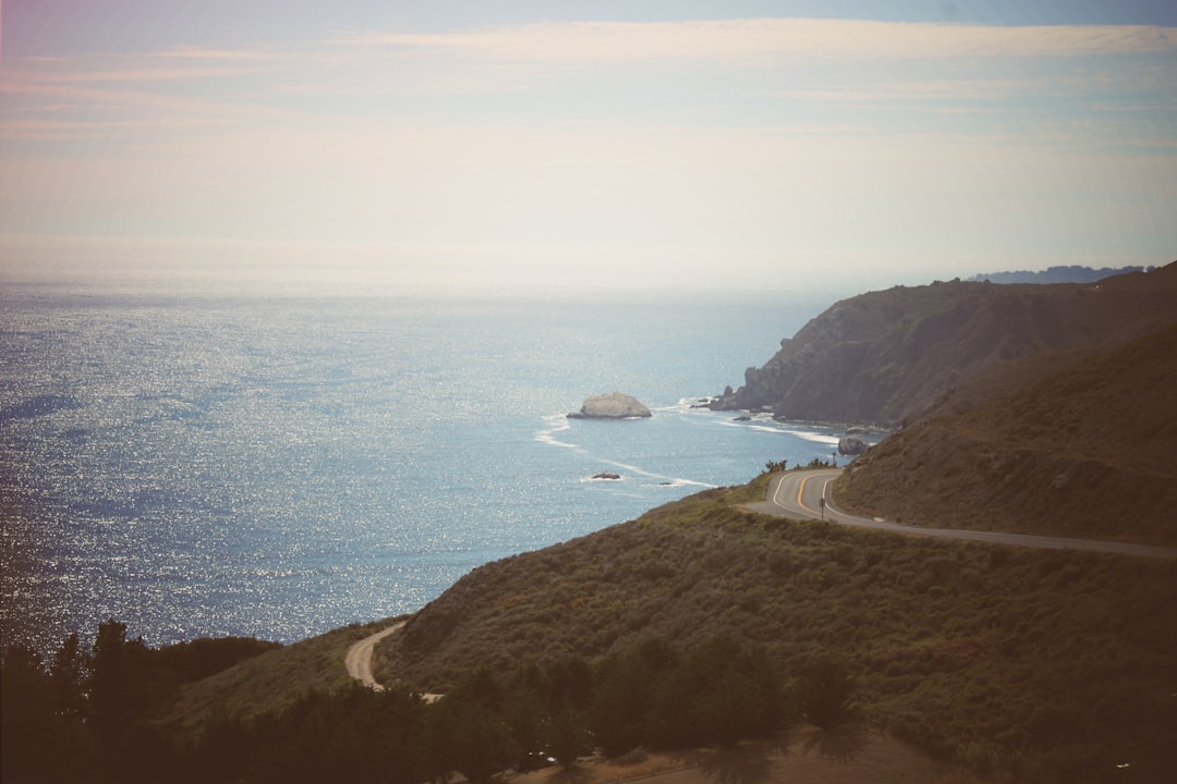 gray road near sea photography, Winding roads