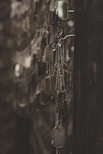 silver-colored god tags hanging on hooks shallow focus photography