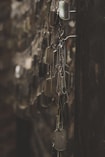 silver-colored god tags hanging on hooks shallow focus photography
