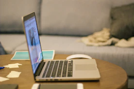 a laptop computer sitting on top of a wooden table