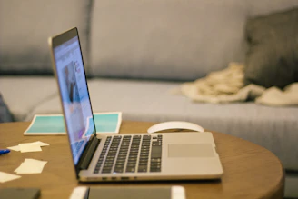 a laptop computer sitting on top of a wooden table