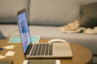 a laptop computer sitting on top of a wooden table