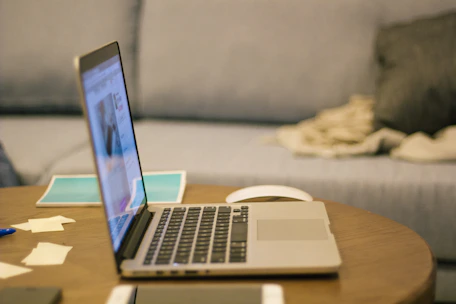 a laptop computer sitting on top of a wooden table