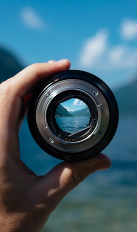 person holding camera lens