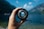 person holding camera lens