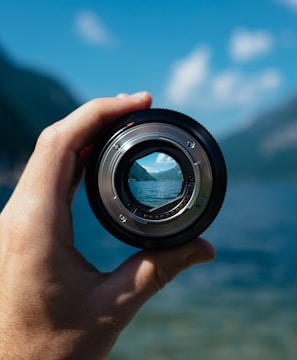 person holding camera lens