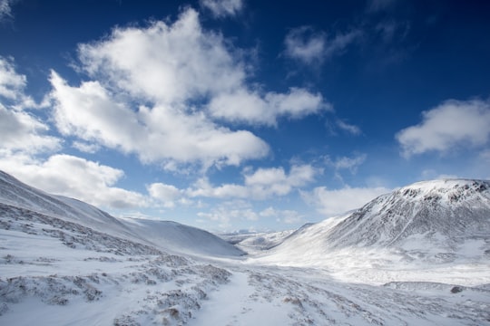 mountain coated by snow during daytime in Cairngorms National Park United Kingdom