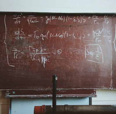 written equations on brown wooden board