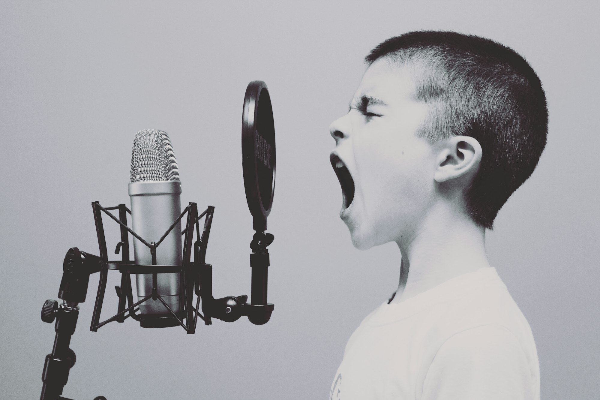 A kid yelling into a microphone, sure to produce feedback