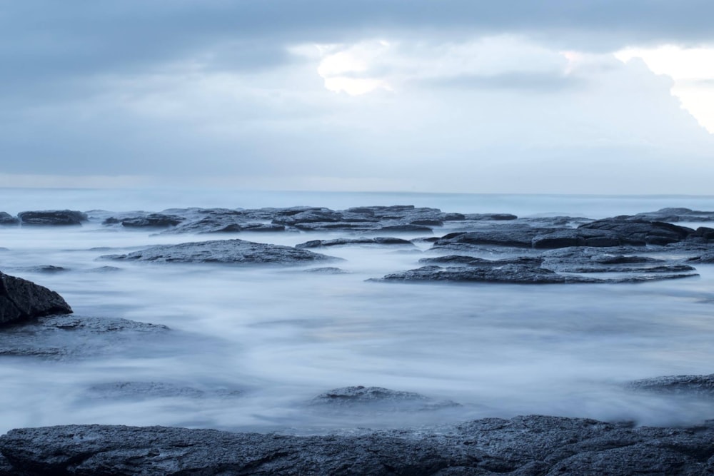 body of water with rocks