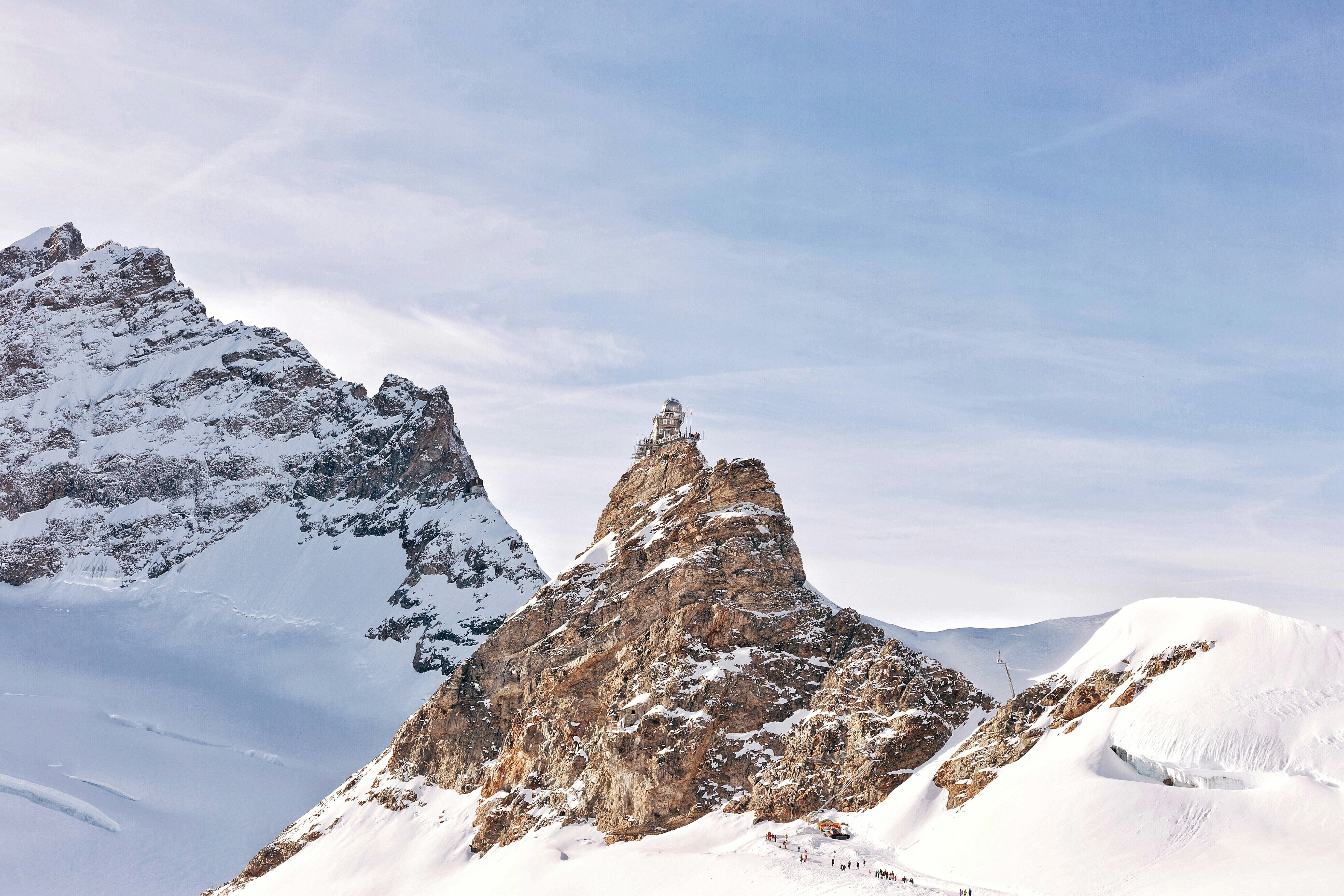 stony mountain covered in white snow