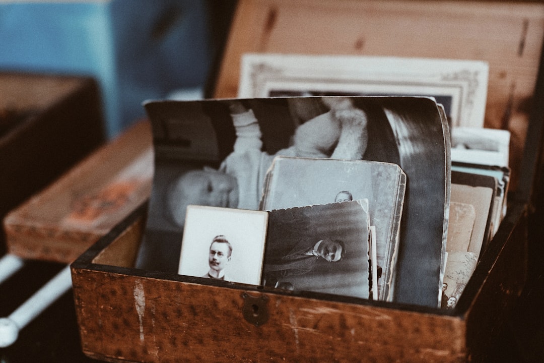 old photos in brown wooden chest,