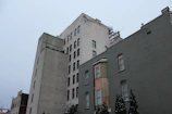 A gritty urban street in Chicago showing a mix of old buildings and new gentrified apartments.