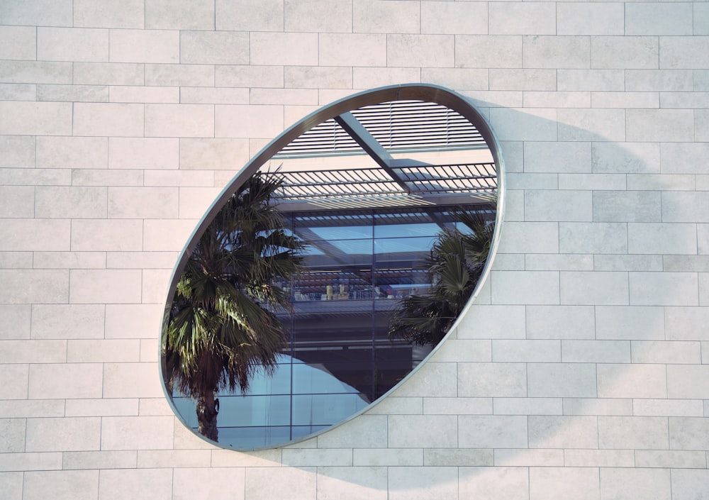 oval mirror on white brick pathway