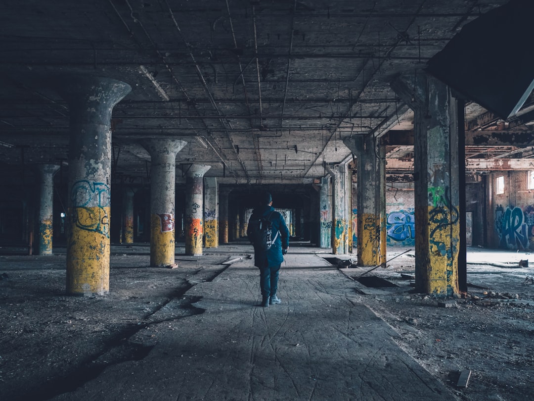 man walking hallway during daytime