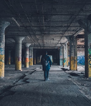 man walking hallway during daytime