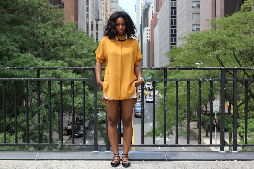 woman standing on brown bridge during daytime