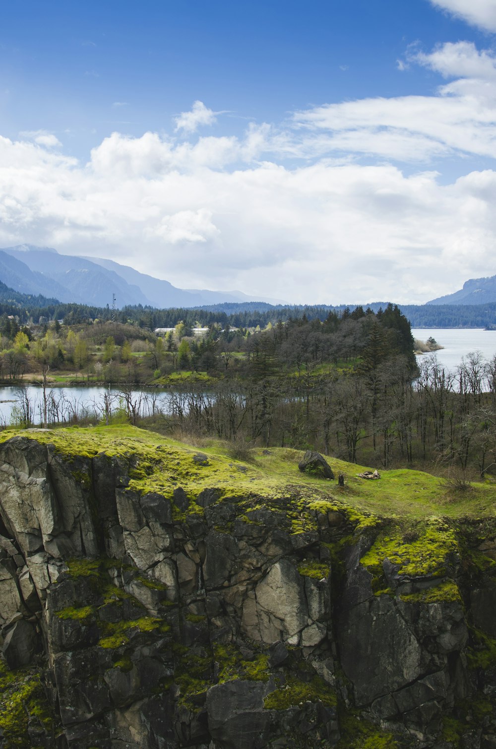 aerial photo of green cliff and river under blue sky during daytime