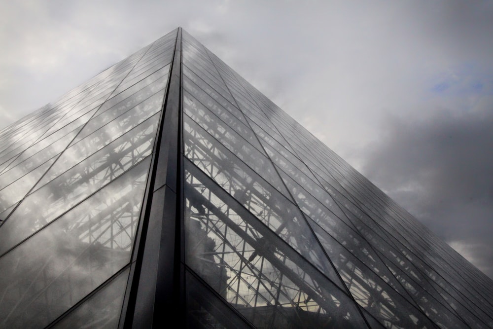 The glass wall exterior of a large French building.