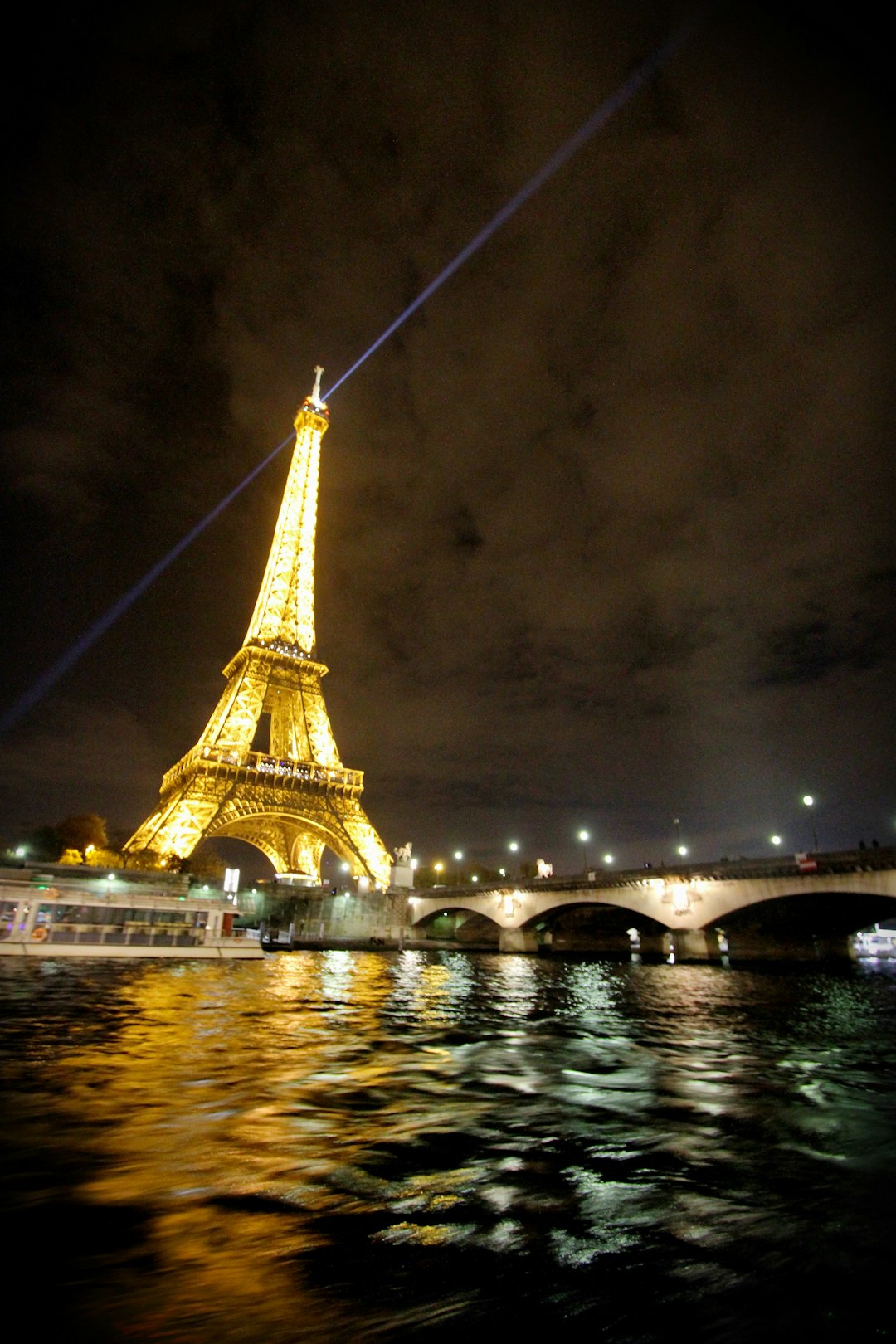 A night-time shot of the brightly lit Eiffel Tower in Paris.