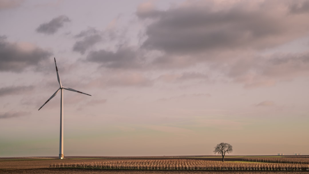 windmill under cloudy sky during daytime