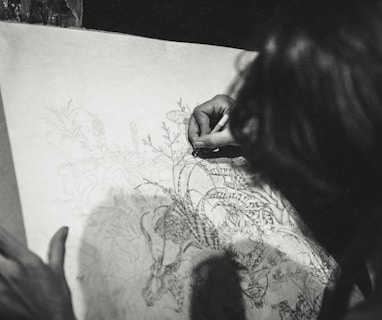 grayscale photo of a woman drawing a flowers
