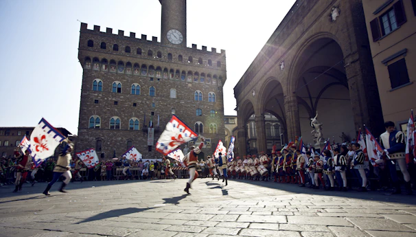 A panoramic view of a lively piazza filled with people celebrating Casate in Festa with games and tournaments.