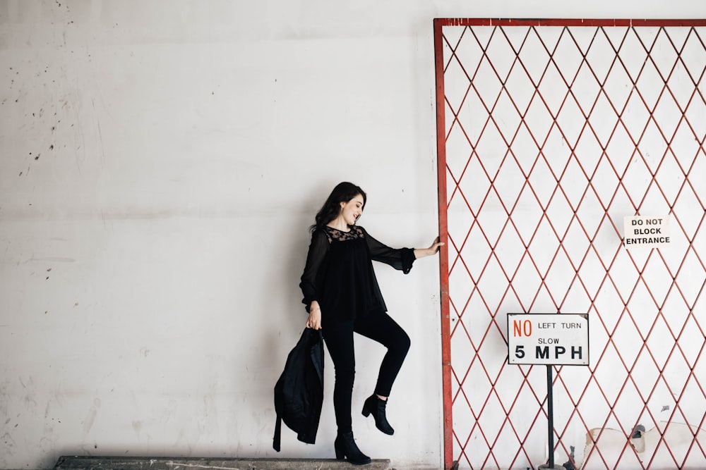 woman carrying black bag