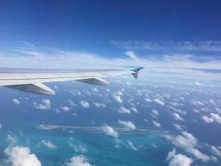 A scenic aerial view of a tropical island destination from the airplane window.