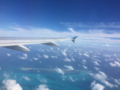 A scenic aerial view of a tropical island destination from the airplane window.