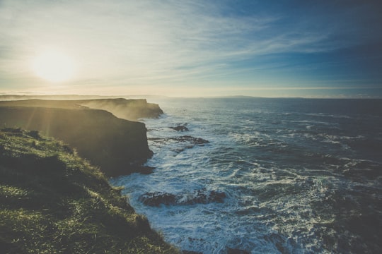 rock cliffs facing rippling body of water in Giant's Causeway United Kingdom