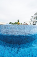 a blue swimming pool with a pineapple on top of it