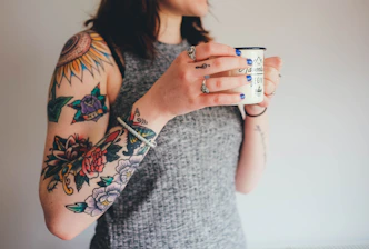 woman holding white ceramic mug