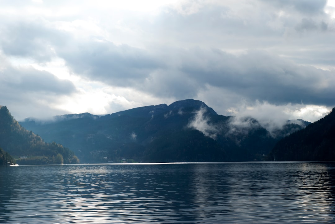 silhouette photo of mountains beside sea