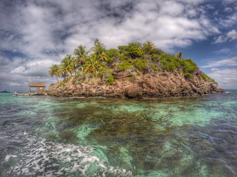 island over white clouds at daytime