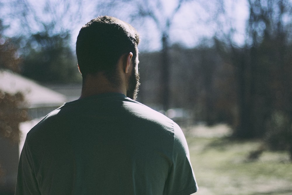 selective focus photography of man staring at woods