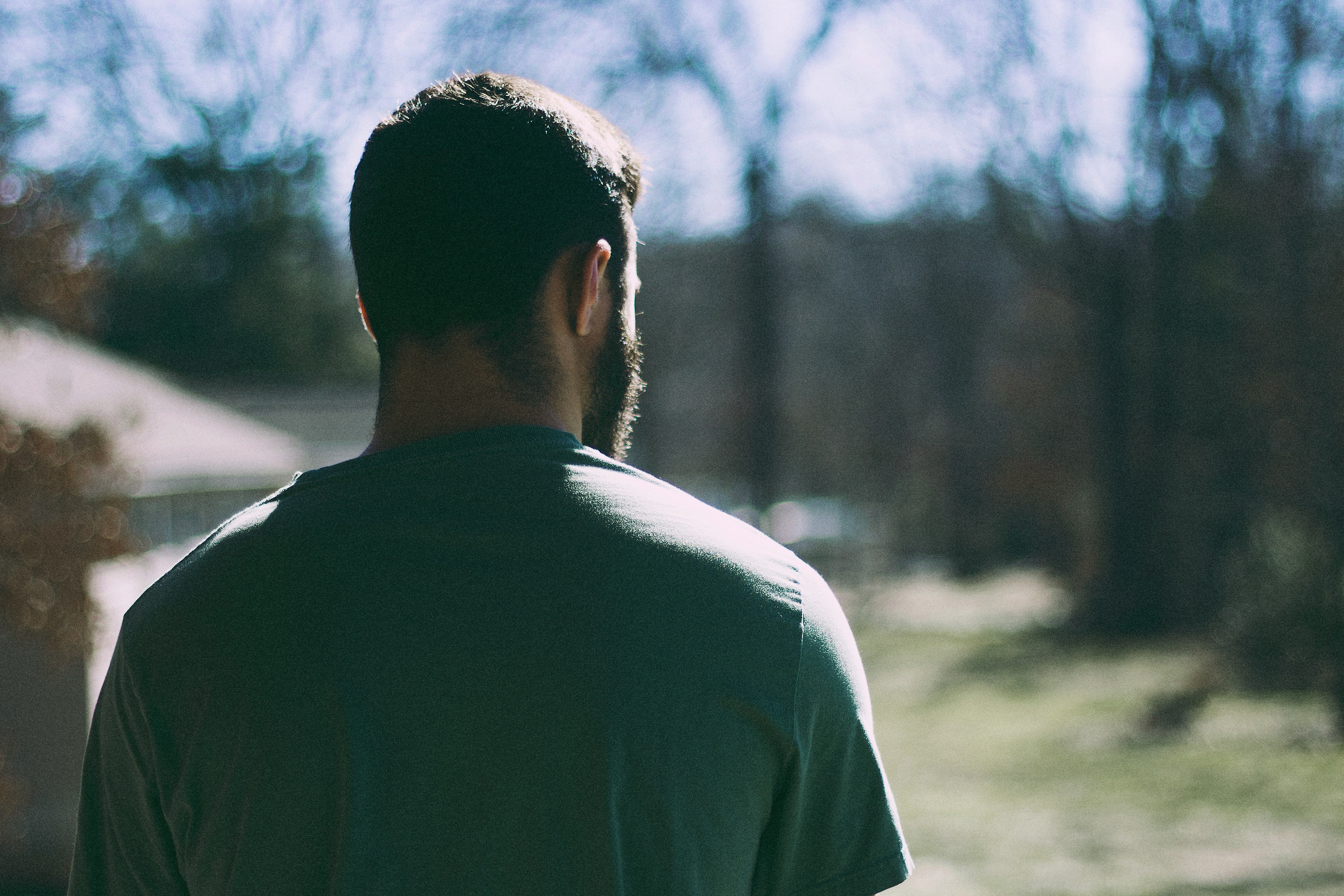 selective focus photography of man staring at woods