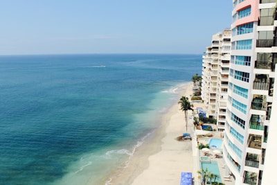 white concrete high-rise buildings near body of water during daytime