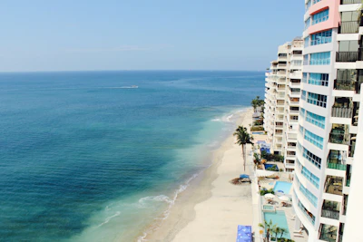 white concrete high-rise buildings near body of water during daytime