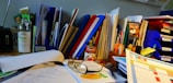 An overhead view of a desk with various office supplies and documents.
