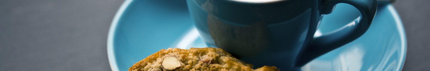 cup of coffee and bread on saucer closeup photography
