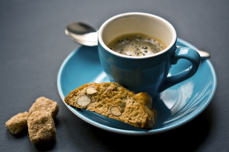 Almond biscotti beside a cup of espresso