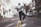 man jumping on the middle of the street during daytime