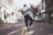 man jumping on the middle of the street during daytime