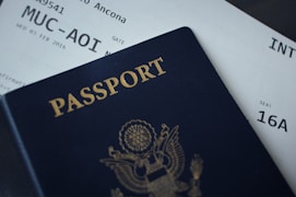 passport booklet on top of flight ticket