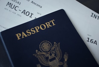 passport booklet on top of flight ticket