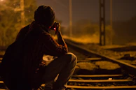 An investigator discreetly following a subject through busy streets of Delhi at dusk.