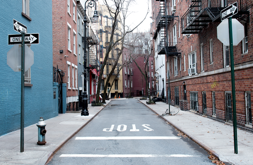 brown concrete street surrounded by buildings